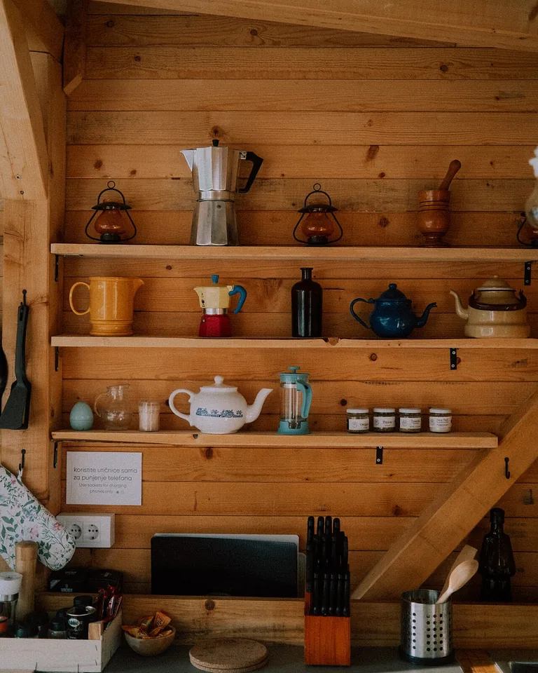 Warm wooden kitchen interior with open shelves and cooking tools