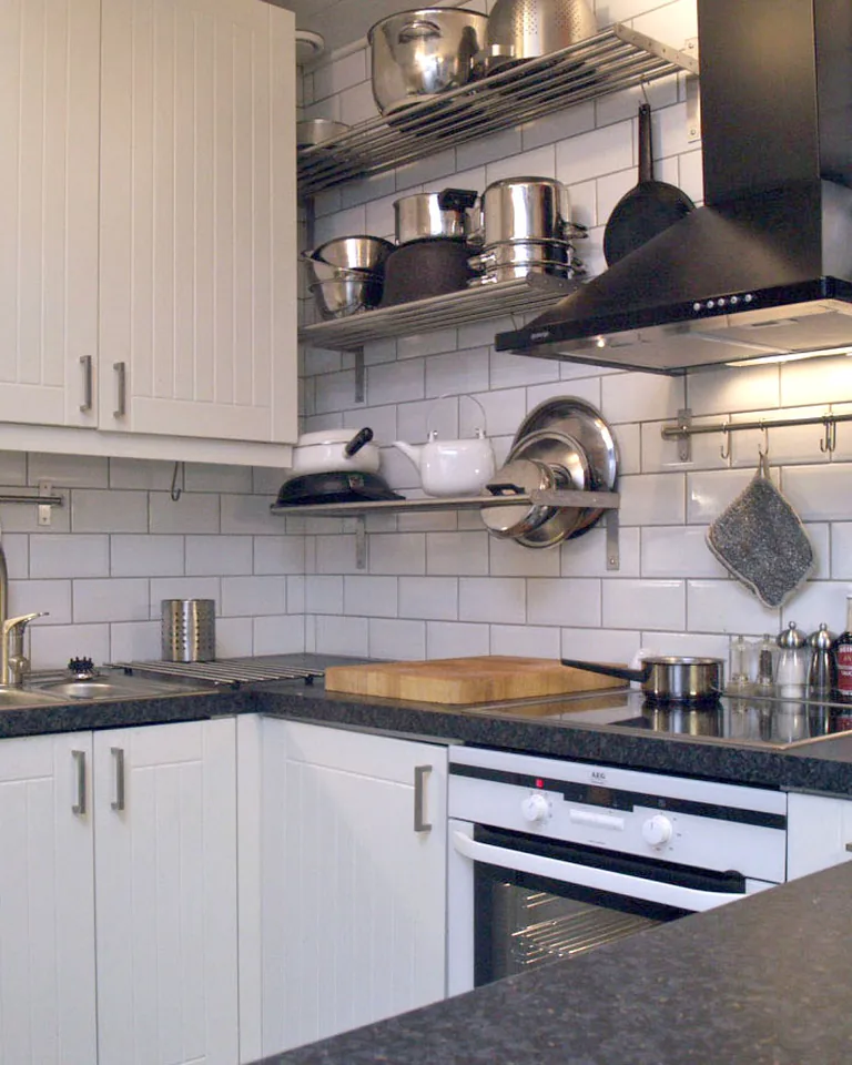 White kitchen with black accents and subway tile
