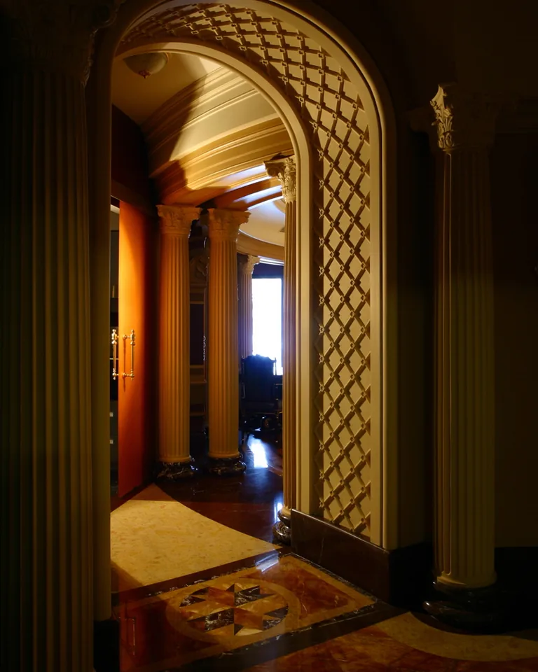 Narrow apartment hallway with doors leading to rooms