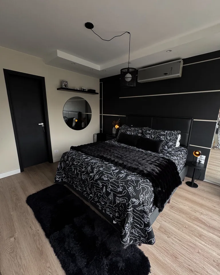 Elegant black-themed bedroom with modern decor
