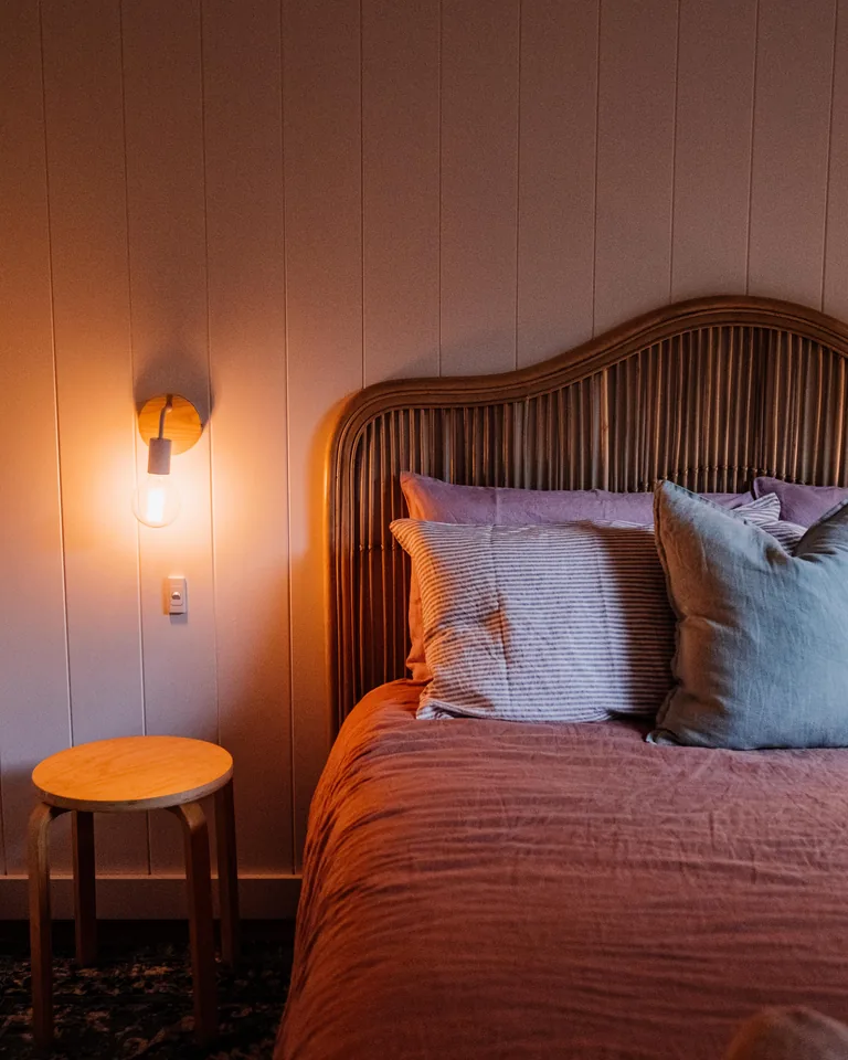Warm bedroom interior with stylish bedding and soft ambient lighting