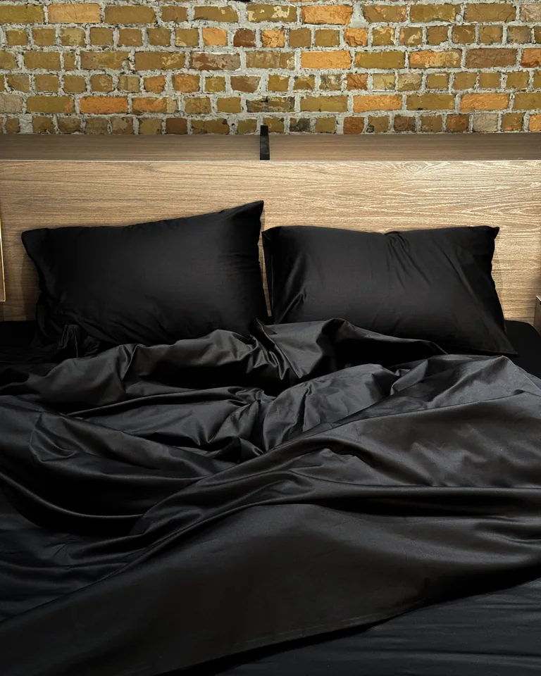 Close-up of black linen bedding showing rich texture