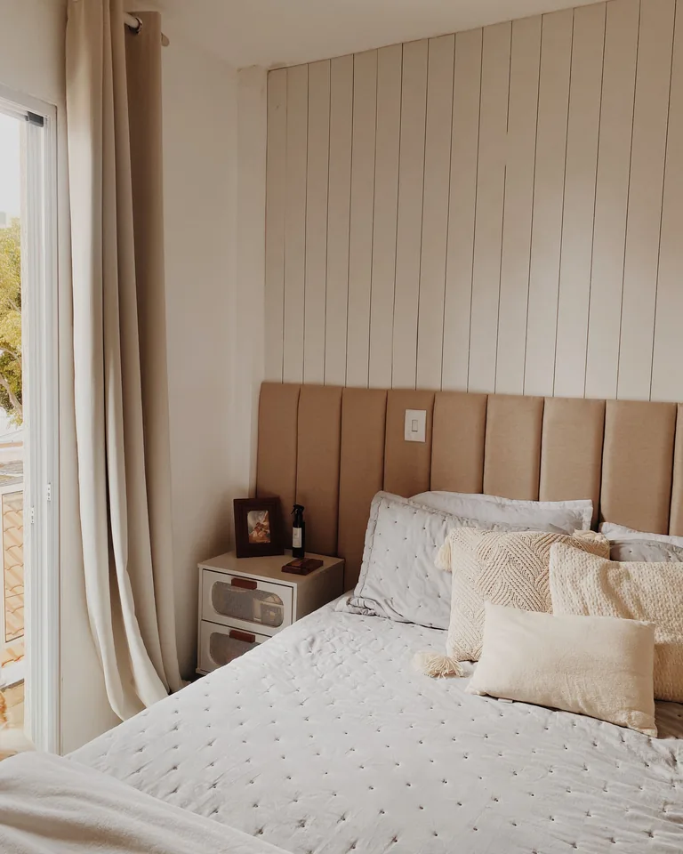 Beige-toned bedroom with shiplap walls and modern decor