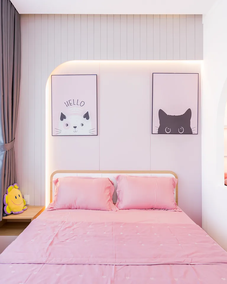 Bright bedroom decorated with layered pink decor and textiles