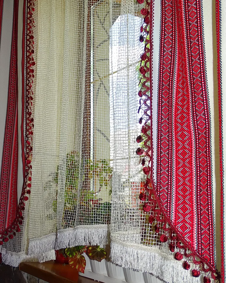 Window dressed with an embroidered sheer curtain